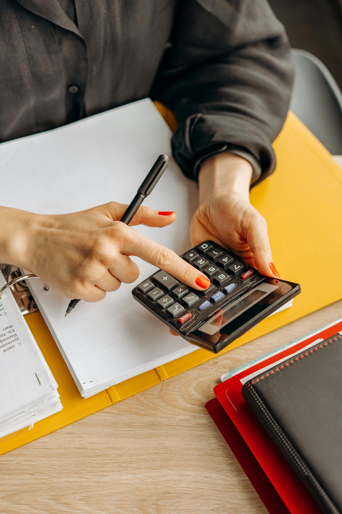 Calculator and documents on a desk for tax preparation